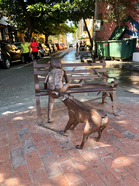 what to do in cartagena, cartagena turismo, tripadvisor cartagena, things to do in Cartagena, colombia, getsemani, places to stay in cartagena, street art, metal sculpture of a boy getting his pants pulled by a dog