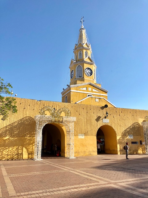 what to do in cartagena, cartagena turismo, tripadvisor cartagena, things to do in Cartagena, colombia, clock tower, yellow wall with a yellow steeple overlooking it