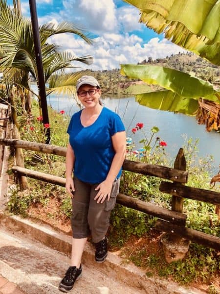 Me standing on an overlook of the ocean, palm trees, flowers 