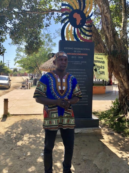 Best day trip from Cartagena, san Basilio de palenque, day trips from cartagena, what to do in cartagena, man wearing brightly colored native attire