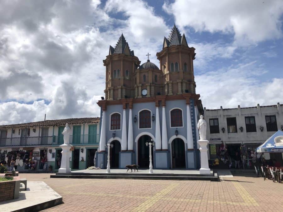 medellin, things to do in medellin, Guatapé, Guatape colombia, day trips from medellin, guatape, places to visit in colombia, day trips from medellin, replica of a beautiful chirch that is grey with white trim on the bottom and brown on top
