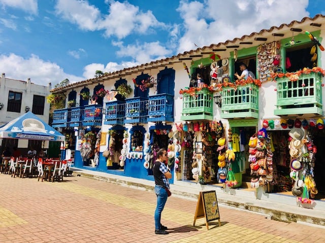 medellin, things to do in medellin, Guatapé, Guatape colombia, day trips from medellin, guatape, places to visit in colombia, colombia tourist attractions, day trips from medellin, brightly colored building with blue and green balconies