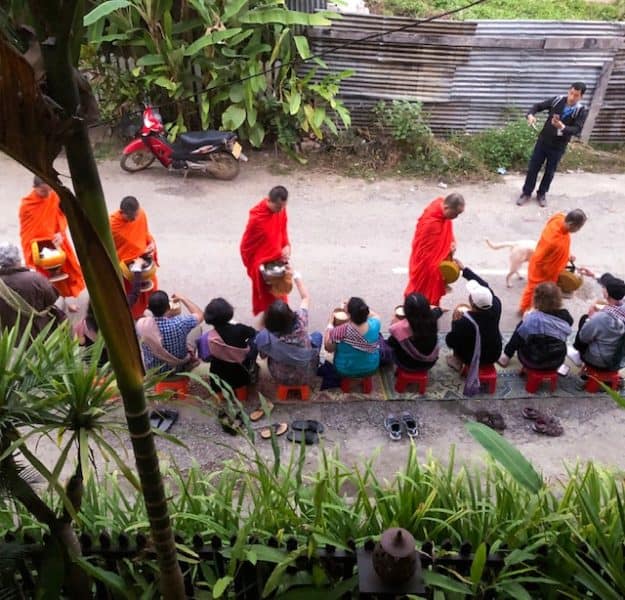 things to do in Luang Prabang, what to do in luang prabang, luang prabang province, unesco world heritage, alms giving ceremony, alms giving, monks dressed in bright orange collecting alms from people kneeling in front of them
