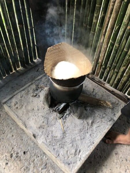 things to do in luang prabang, living land, rice cooking in a straw bowl