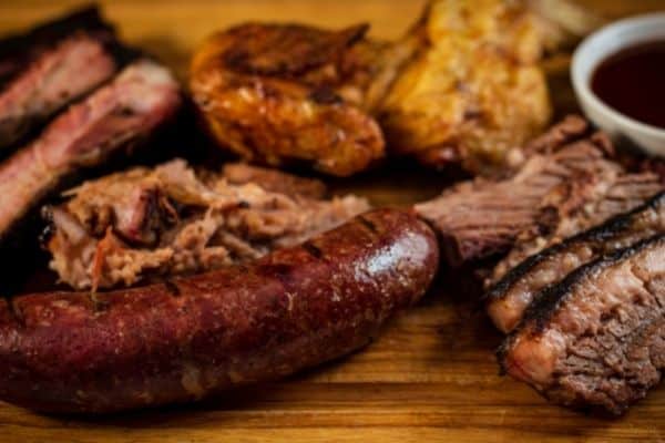 sausage, pulled pork, barbecue sauce in small dish, Barbecue in Charleston, things to do in charleston sc, must do in charleston sc, things to so in south carolina charleston, places to in charleston sc