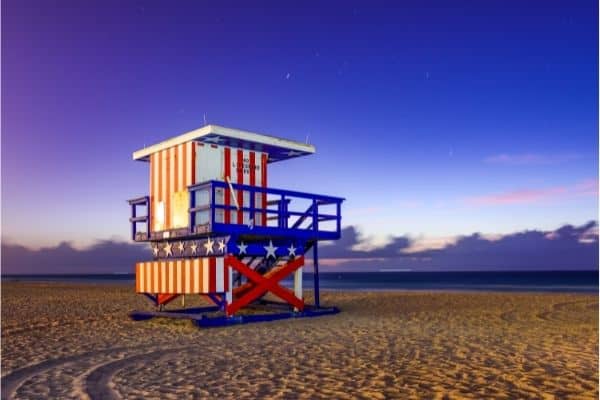 red white and blue lifeguard station on the beach