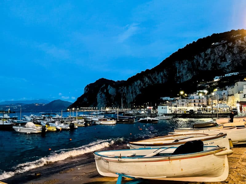 sunset on capri shores, lit up boats