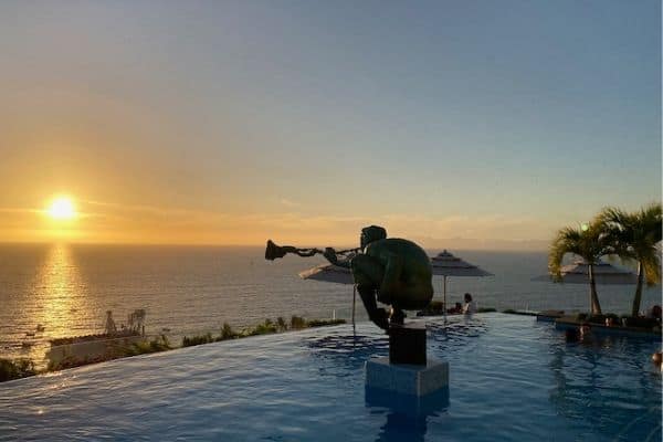 sunset over pool, statue playing the trumpet, beach puerto Vallarta, what to do in puerto Vallarta, traveling to puerto Vallarta, puerto vallarta trips
