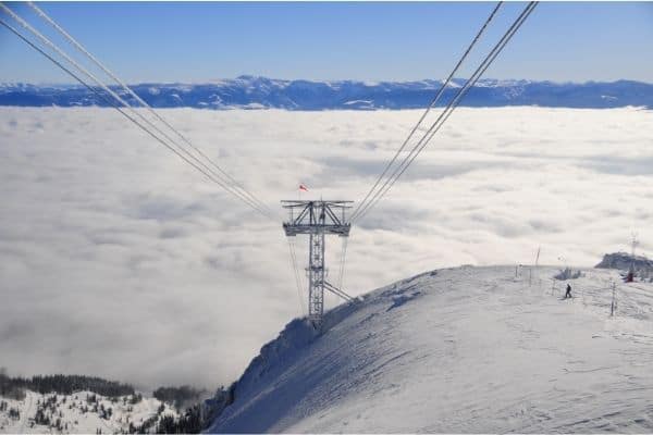 point of view from ski lift, snow covered mountains in the distance, skiing in jackson hole, what to do in jackson hole, things to do in jackson hole wyoming, 