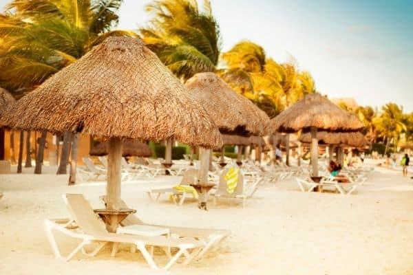 beach cabanas, people relaxing on beach chairs, playa del carmen attractions, playa del carmen activities