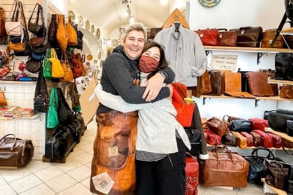 stacey and friend hugging in leather shop, visit umbria 