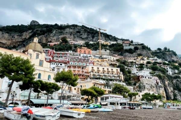 view of positano, boats on the shore, positano, towns in the amalfi coast