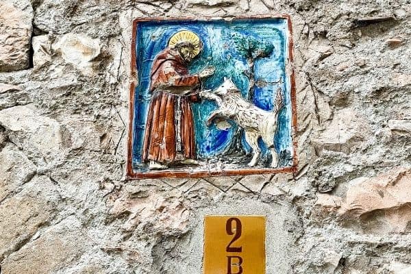 painting of st francis with a sheep, patron saint, 13th century, medieval town