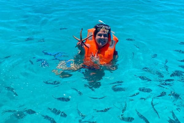 me snorkeling holding a starfish