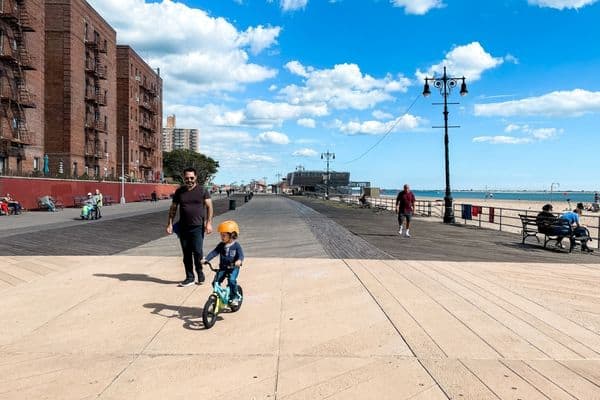brighton beach, brighton beach new york, man and child on a bike, boardwalk