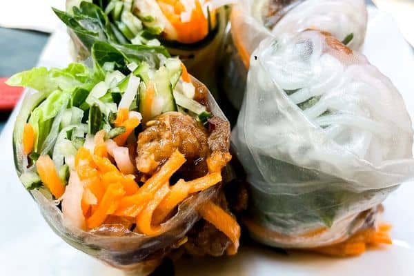 spring rolls with carrots, lettuce, and onions