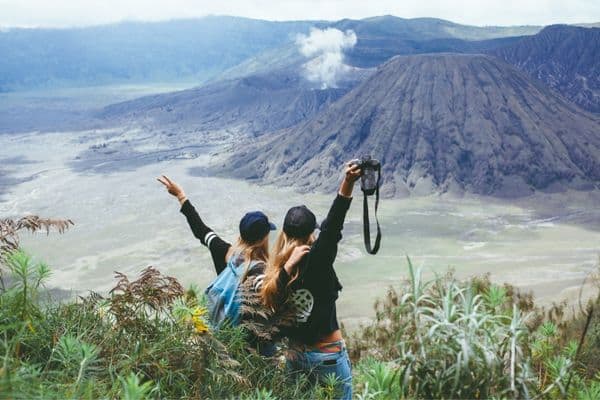 women looking at volcano, best travel backpack for women