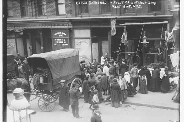 sepia and white photo of a carriage and a crowd gathering around a building, NY kosher meat riot

