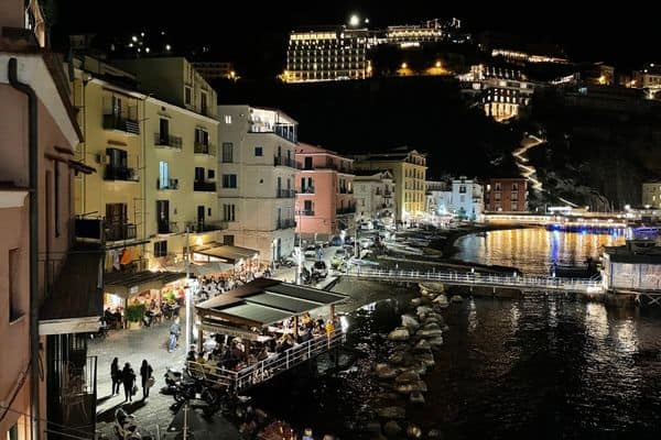 night view of sorrento, buildings lit up on the hill in distance