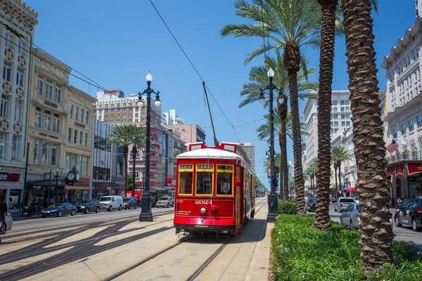 red streetcar in streets of new orleans, how to get around new orleans