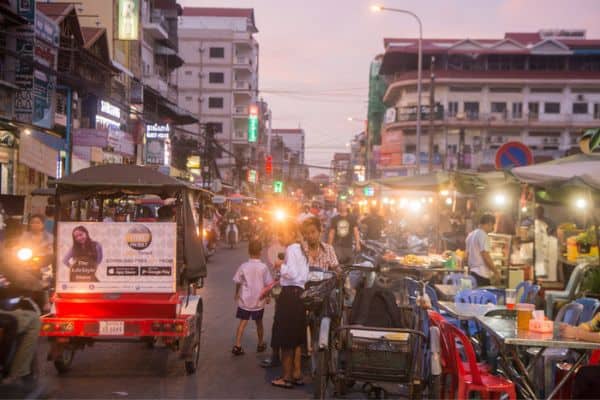 night market, tuk tuk and motorbikes in road, vegetable vendors, phnom penh nightlife, 
