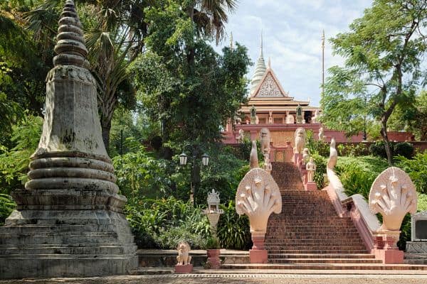 wat phnom, stairs to temple, tall trees, lion statues at entrance