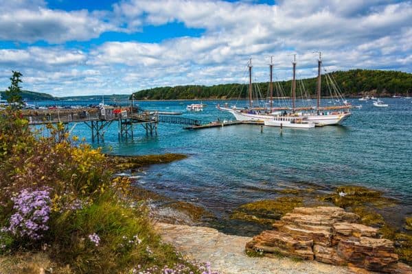 bar harbor, boat in the distance, rocky path leading to the harbor