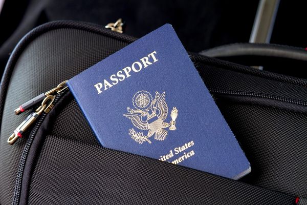 american passport in black bag, pack a carry on, how to pack a carry on, how to pack a carry on bag, item bags, weekender bag, personal item packing list
