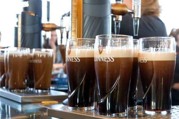 fresh pints of guinness being poured from the tap, guinness storehouse, visit dublin