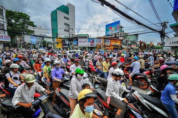 crowded street with people on motorbikes, traffic jam, where to stay in ho chi minh city 