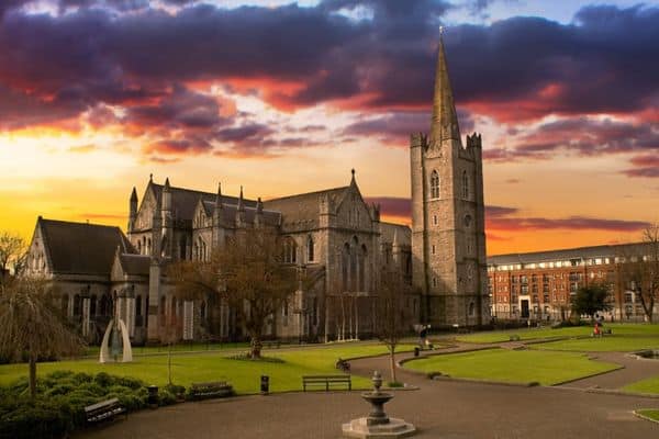 sunset over st. patrick's cathedral, red and purple clouds in the sky, outdoor activities dublin, places to go in dublin, things to do in dublin for families