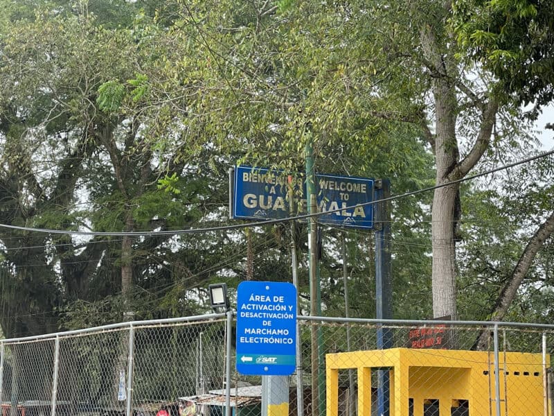 immigration border to guatemala, sign welcoming people to guatemala, border fence, visiting tikal from san ignacio
