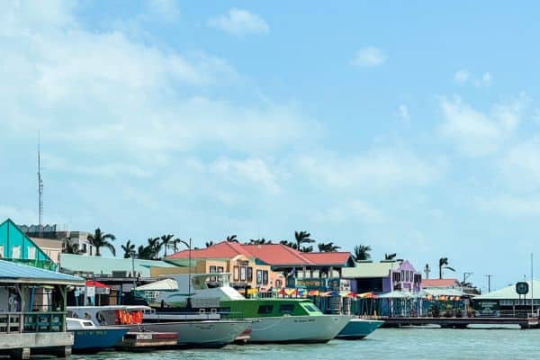 boats at the dock, colorful beacj homes, palm trees in the distance, san bedro belize, things to do in ambergris caye, ambergris caye hotels, ambergris caye resorts