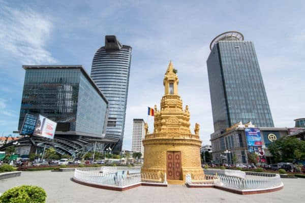downtown square of phnom penh, monument in the center, tall buildings in the background