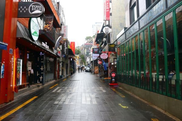 clean street of itaewon, empty stree with signs advertising restaurants
