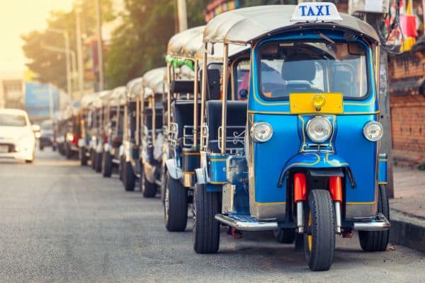 blue tuk tuk taxis waiting in a line