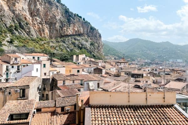 view from the duomo tower, buildings and homes of cefalu seen below, mountain in the distance