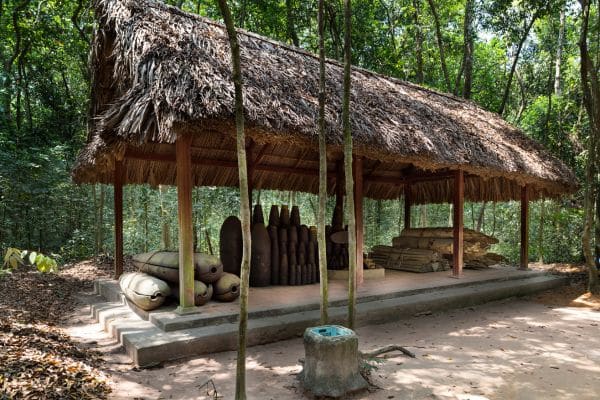 entrance to one of the cu chi tunnels, small pavilon with supplies, covered entrance to one of the tunnel holes, ho chi minh day tours
