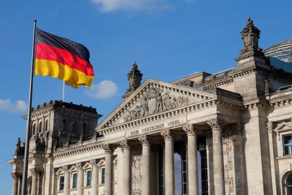 german flag flying high above german government building 