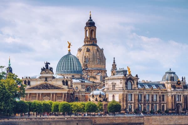 dresden germany, berlin to dresden day trip, government building in dresden, german architecture building with domes and figurines on top of the domes 