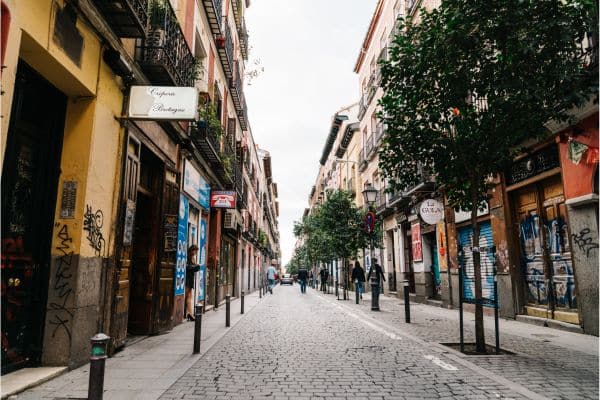 quiet street of Malsana, shops with signs, cobbestone street, where to stay in madrid, madrid where to stay