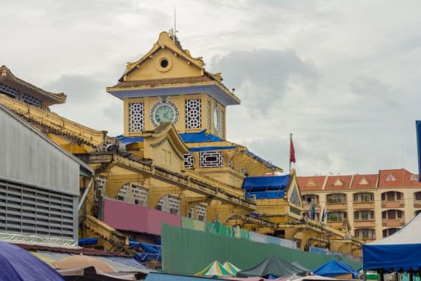 binh tay market, up close view of the clock tower at the top of the market, cloudy skies