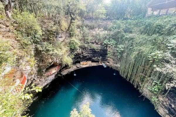 beautiful view from the top of a cenote, dark blue water down inside the cave, cenotes close to merida mexico, day trips from merida mexico