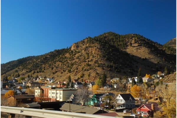 idaho springs town, hills in the background with homes and downtown area seen in the front