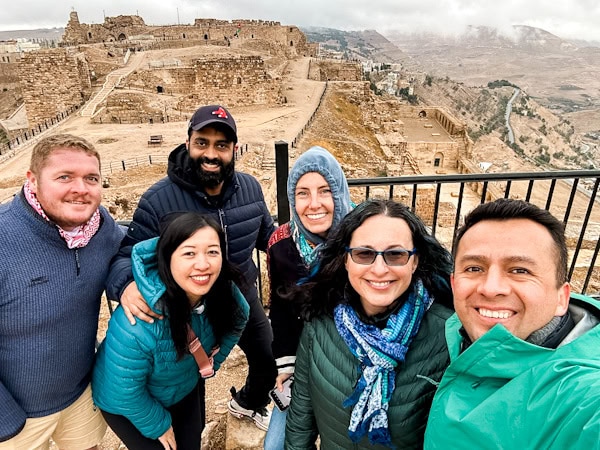 group photo selfie with the jerash remains in the background, g adventures highlights of jordan, g adventures jordan