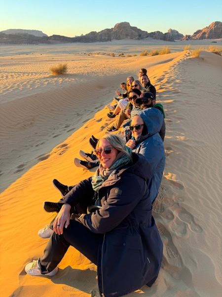me and the others in my group sititing on top of one of the sand dunes in wadi rum