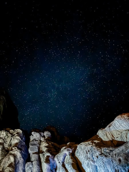 incredible views of the stars in wadi rum with the rock arches down below 